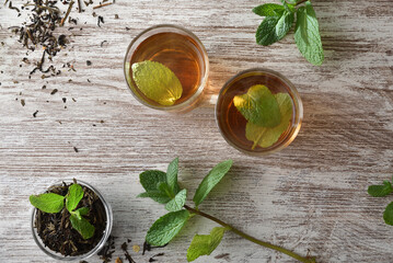 Two freshly brewed green teas with mint on wooden table