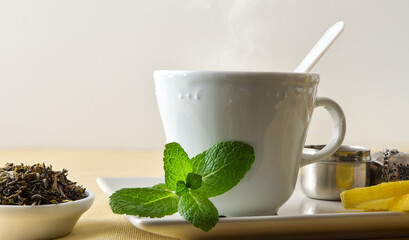Macro teacup with mint and lemon white isolated background