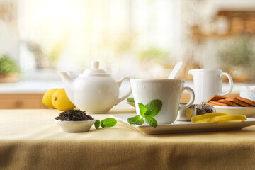 Breakfast with green tea on a kitchen table with tablecloth