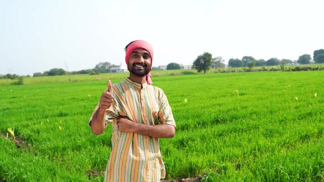 indian farmer showing thumps up at agriculture field 