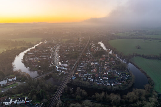 Aerial view of the winding River Tees embracing the historic town of Yarm under a soft, golden sunrise, North Yorkshire's charm unveiled from above., Yarm, North Yorkshire, England.