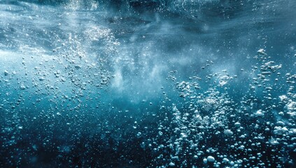 Bubbles rise in deep blue water, creating an abstract underwater texture
