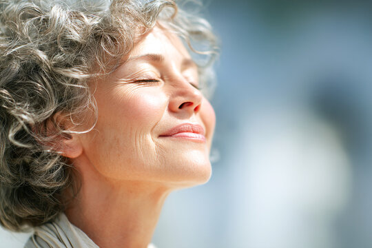 Elderly woman enjoying a moment of peace in natural light outdoors Generative AI