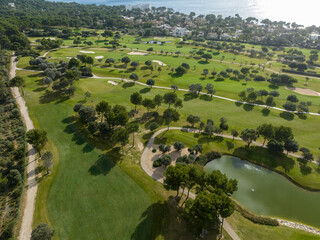 Aerial view, Spain, Balearic Islands, Mallorca, Capdepera, Cuevas de Arta and Platja de Canyamel with golf course, sand bunker, green, golfer