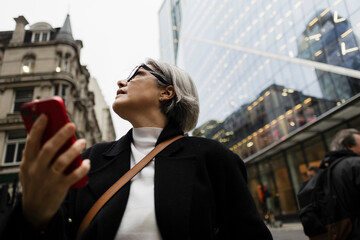 Femal tourist navigating city streets with smartphone