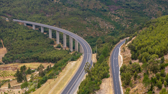 Aerial view of the Du Toitskloof Pass Viaduct cutting through the landscape, its stark concrete contrasting with the verdant hillsides, Paarl, Western Cape, South Africa.