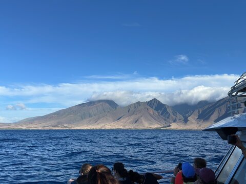Ocean Tour Boat Passengers Watching Volcanic Island in Maui Hawaii