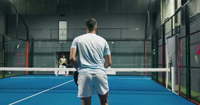 Back, man and serve for padel on court of fitness contest, exercise or swing technique for match. Athlete, people and hitting ball with racket for sports game, tennis competition and tournament event