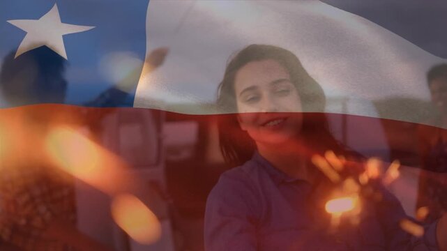 Animation of waving chile flag over group of friends on the beach