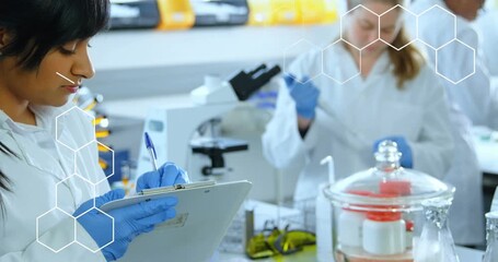 Animation of shapes over group of diverse scientists in lab - Powered by Adobe