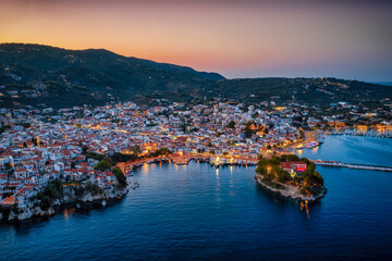 Panoramic summer evening aerial view of the illuminated town of Skiathos island, Sporades, Greece,...