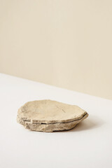 Background for cosmetic products of natural beige color. Stone podium on a white background. Front...