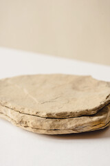 Background for cosmetic products of natural beige color. Stone podium on a white background. Front...