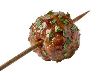 Glazed meatball appetizer on a wooden skewer with fresh parsley