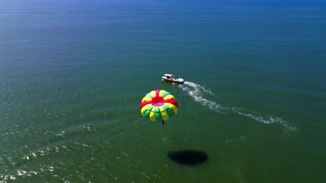 Arabian Sea with speed boat parasailing dip at colva, south goa, india. day time, push in shot, close-up shot, drone shot, 4k.