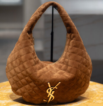 ICARE hobo bag in cognac-coloured quilted suede with check pattern, golden YSL logo. Milan - Italy, 6 January 2026