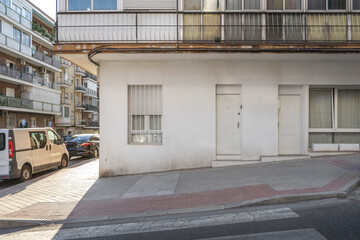 Facade of a modern shop with sliding glass doors and a discreet sign above the lintel of the main entrance