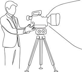 man in suit operating large video camera on tripod stand