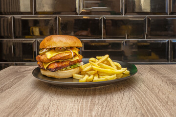 The visual spectacle of a double 'chef' burger, sliced ​​in half to reveal its perfectly defined layers, with crispy patatas bravas smothered