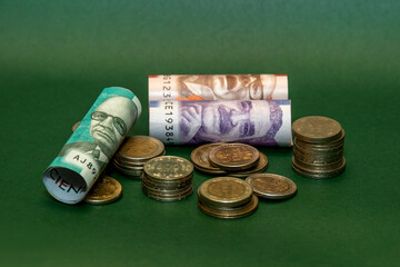 Colombian peso banknotes and coins symbolizing savings, the economy, and the minimum wage.Close-up...