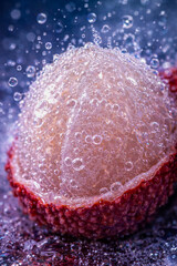 Close-up of a lychee with bubbles and water splashes captured in detail during a refreshing moment in a studio setup