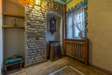 Rustic hallway interior with brick niche and mosaic window decor