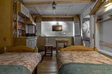 Cozy rustic studio interior with bedroom and wooden kitchen