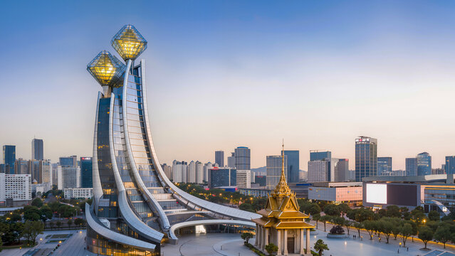 A modern architectural complex with unique towers topped with golden crystals in Phnom Penh, Cambodia. The cityscape at dusk combines traditional Khmer style with high-tech architecture. Wide-angle, s