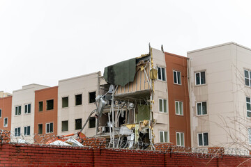 Building damaged in construction accident at urban site in early morning hours
