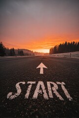 Obraz premium Road marking with start and arrow at sunset symbol of beginning