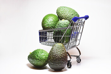 Avocados, tropical fruits, in front shot and white background, copy space.