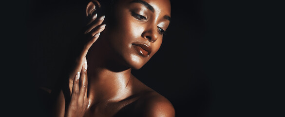 Skincare, space and Indian woman on dark background with touch, natural glow or smooth texture with shimmer. Beauty, shine and girl in studio with softness, mockup and radiant skin in body care. © BuyOutFelix05/peopleimages.com