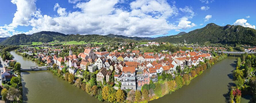 Aerial view of a charming town where terracotta roofs meet the river Mur, nestled against a backdrop of verdant mountains, Frohnleiten, Styria, Austria.