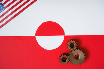 United States and Greenland relations concept with metal gears and blurred flags. US- Greenland Geopolitical Interests. Top view. Copy space.