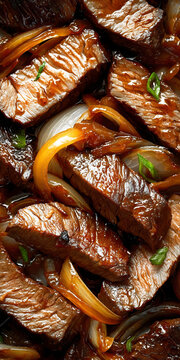 Brazilian boteco filet mignon strips with caramelized onions and green garnish in a pan.