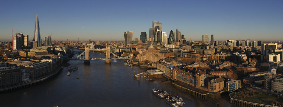 Aerial view of the majestic Tower Bridge over the Thames River, skyscrapers piercing the sky, a blend of historic charm and modern architecture, London, Greater London, United Kingdom.