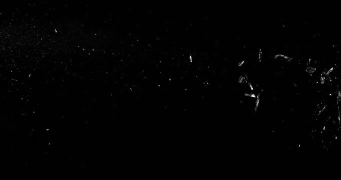 Super slow motion bullet impact shattering glass filmed at 1000fps. Side view of gunshot breaking window with flying shards and dust isolated on black background. Perfect VFX overlay element.