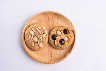 soft cookies with almond macadamia and chocolate on a table and plate