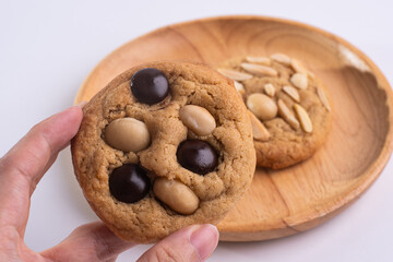 soft cookies with almond macadamia and chocolate on a table and plate