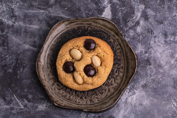 soft cookies with almond macadamia and chocolate on a table and plate