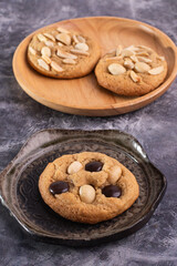 soft cookies with almond macadamia and chocolate on a table and plate