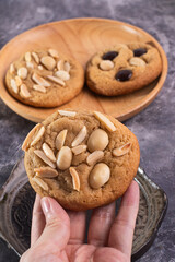 soft cookies with almond macadamia and chocolate on a table and plate