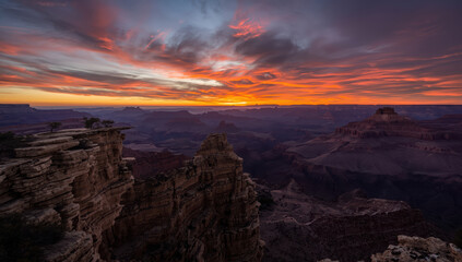 Sunset canyon landscape with dramatic colorful sky and rugged rock cliffs
