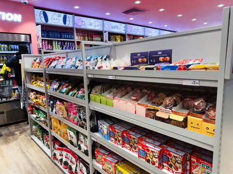 Colorful snack aisles in Kenji Manchester UK convenience store filled with snacks and treats