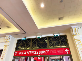 Naklejka premium Indoor lobby with guest services sign and exit indicators in Manchester UK