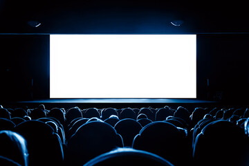 People in the cinema watching a movie. Blank empty white screen