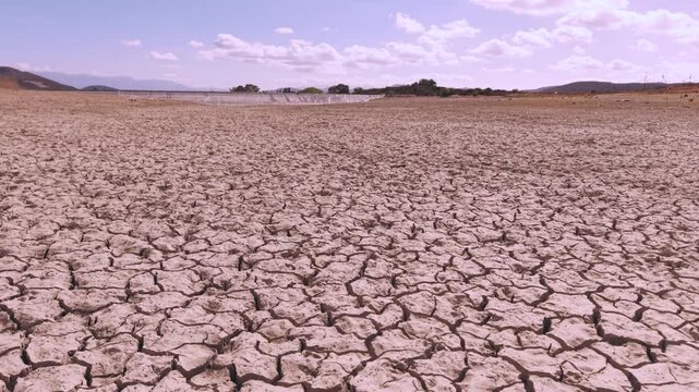 Aerial of dried up dam with cracked earth