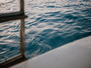 Ocean wave texture seen from a boat, blue background with motion and copy space