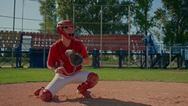 The catcher catches the ball during a baseball practice game. The baseball players train by playing.