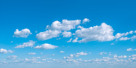 Panoramic background of perfect blue summer sky with beautiful cumulus clouds
